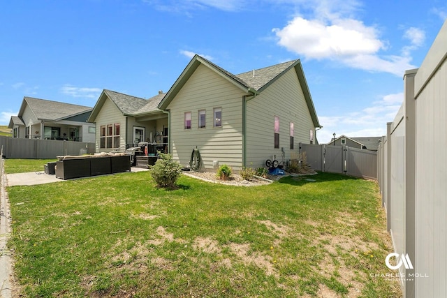 339 Elouise Cobell St, Helena, MT 59601 - back of property with outdoor lounge area, a patio area, a gate, and a shingled roof