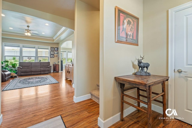 339 Elouise Cobell St, Helena, MT 59601 - entrance foyer with arched walkways, a tray ceiling, baseboards, wood finished floors, and ceiling fan