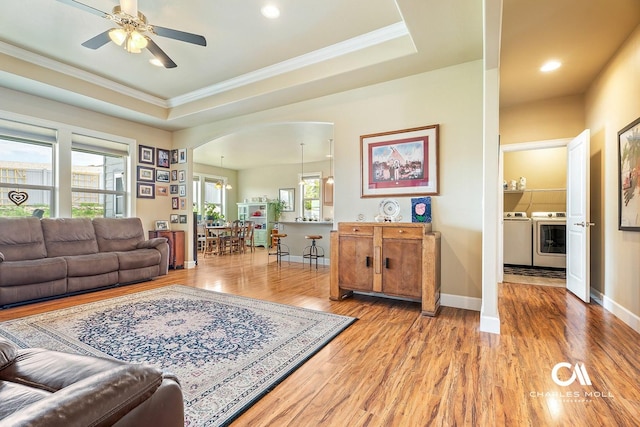 339 Elouise Cobell St, Helena, MT 59601 - living room with separate washer and dryer, light wood finished floors, ornamental molding, plenty of natural light, and a ceiling fan