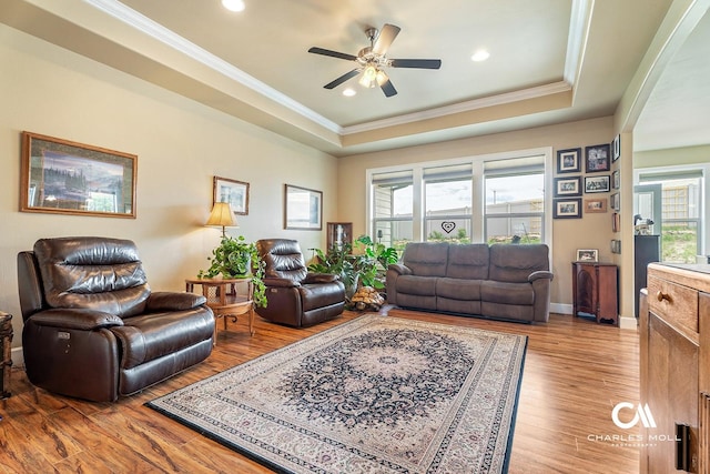 339 Elouise Cobell St, Helena, MT 59601 - living area with a tray ceiling, ornamental molding, healthy amount of natural light, a ceiling fan, and light wood-type flooring