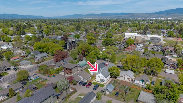 1935 S 12th St W, Missoula, MT 59801 - aerial overview of property's location with a mountain backdrop and nearby suburban area