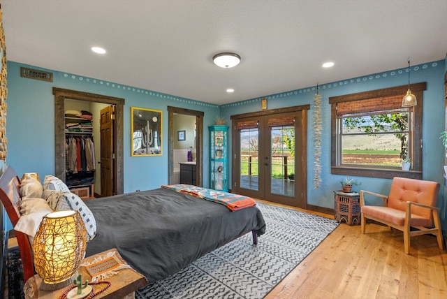 51943 Kuntz Ln, Charlo, MT 59824 - bedroom with french doors, access to exterior, wood finished floors, baseboards, and recessed lighting