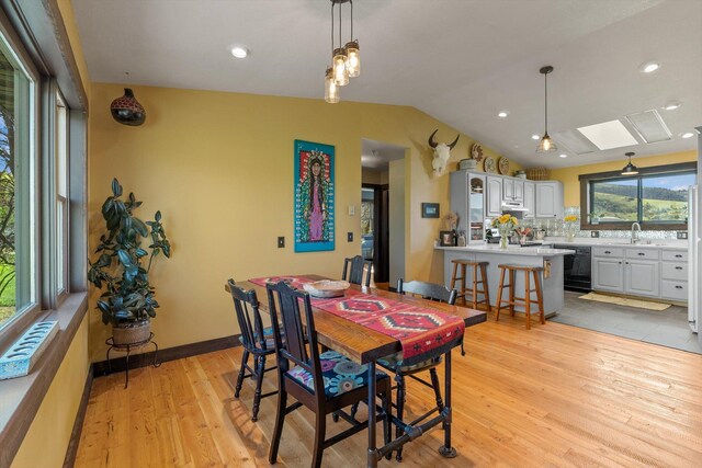 51943 Kuntz Ln, Charlo, MT 59824 - dining room with a skylight, light wood-style flooring, and lofted ceiling