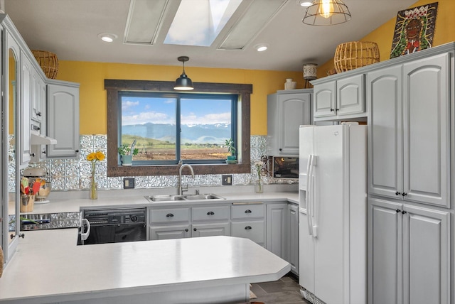 51943 Kuntz Ln, Charlo, MT 59824 - kitchen with white refrigerator with ice dispenser, a sink, black dishwasher, a peninsula, and light countertops
