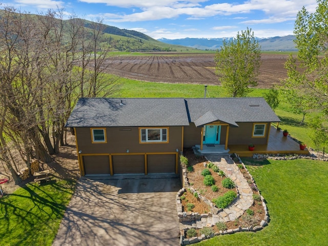 51943 Kuntz Ln, Charlo, MT 59824 - view of front of home with driveway, a garage, a view of countryside, a mountain view, and roof with shingles