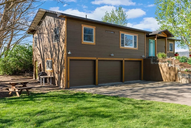 51943 Kuntz Ln, Charlo, MT 59824 - view of front facade featuring an attached garage, driveway, and a front lawn