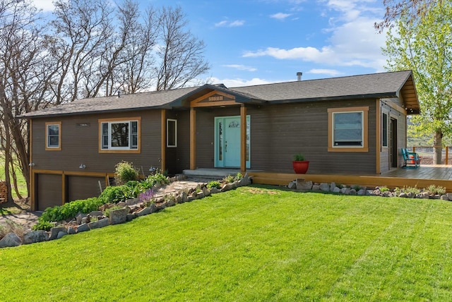 51943 Kuntz Ln, Charlo, MT 59824 - view of front facade featuring an attached garage, a deck, and a front yard