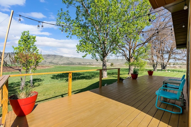 51943 Kuntz Ln, Charlo, MT 59824 - wooden terrace featuring a view of rural / pastoral area, a mountain view, and a yard