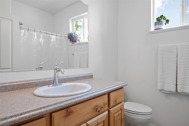 5015 Pius Way, Missoula, MT 59808 - bathroom featuring toilet, vanity, and curtained shower