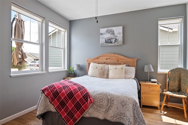 5015 Pius Way, Missoula, MT 59808 - bedroom featuring multiple windows, wood finished floors, and baseboards