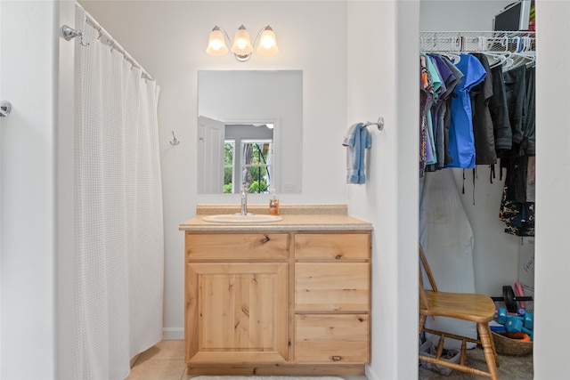 5015 Pius Way, Missoula, MT 59808 - bathroom with vanity, a spacious closet, a shower with curtain, tile patterned floors, and baseboards