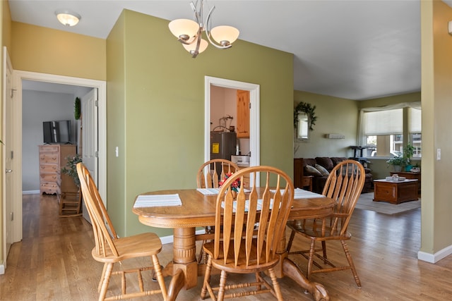 5015 Pius Way, Missoula, MT 59808 - dining room featuring electric water heater, light wood finished floors, a chandelier, and baseboards
