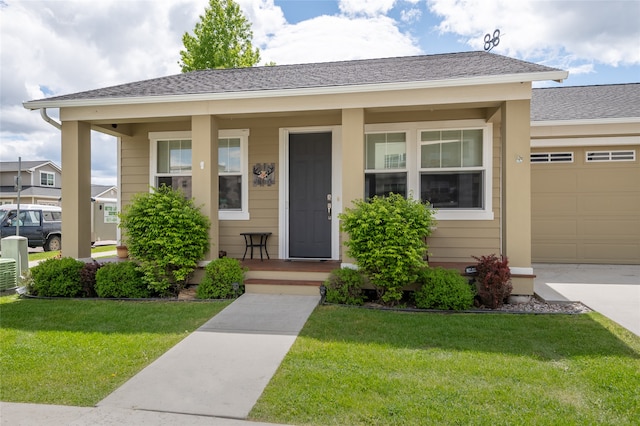 5015 Pius Way, Missoula, MT 59808 - view of front of home with covered porch, a garage, a front yard, and concrete driveway