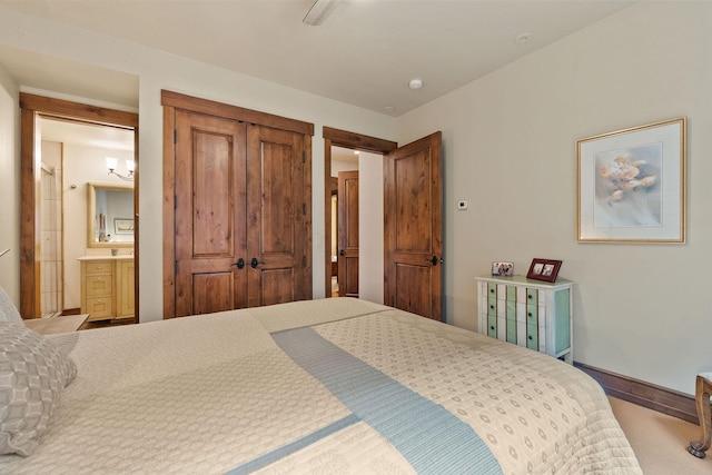 5675 US Highway 93 S Unit 10, Somers, MT 59932 - carpeted bedroom with baseboards, a closet, and ensuite bath