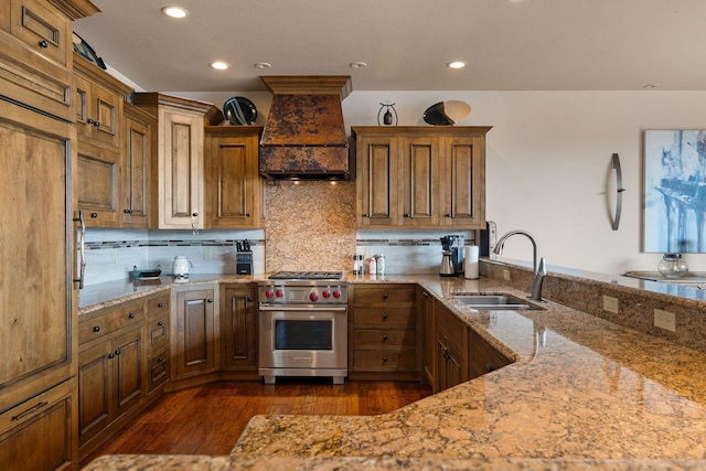 5675 US Highway 93 S Unit 10, Somers, MT 59932 - kitchen featuring luxury stove, a sink, custom range hood, dark wood finished floors, and light stone counters
