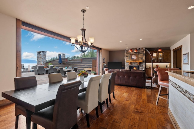 5675 US Highway 93 S Unit 10, Somers, MT 59932 - dining room featuring hardwood / wood-style floors, a fireplace, a chandelier, floor to ceiling windows, and recessed lighting