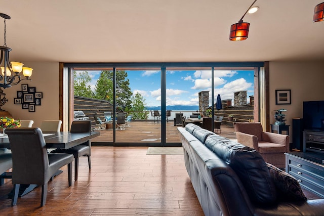 5675 US Highway 93 S Unit 10, Somers, MT 59932 - living room featuring expansive windows, a chandelier, and hardwood / wood-style floors