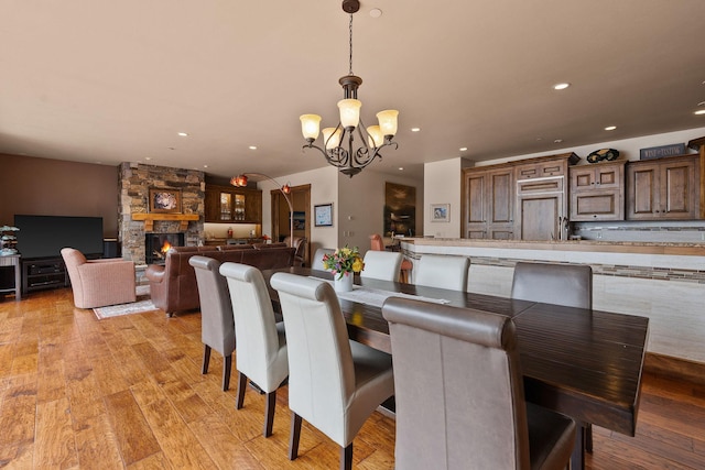 5675 US Highway 93 S Unit 10, Somers, MT 59932 - dining area with a chandelier, recessed lighting, light wood-style floors, and a stone fireplace
