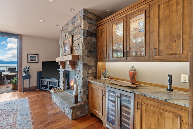 5675 US Highway 93 S Unit 10, Somers, MT 59932 - indoor bar featuring beverage cooler, a fireplace, wood finished floors, baseboards, and recessed lighting