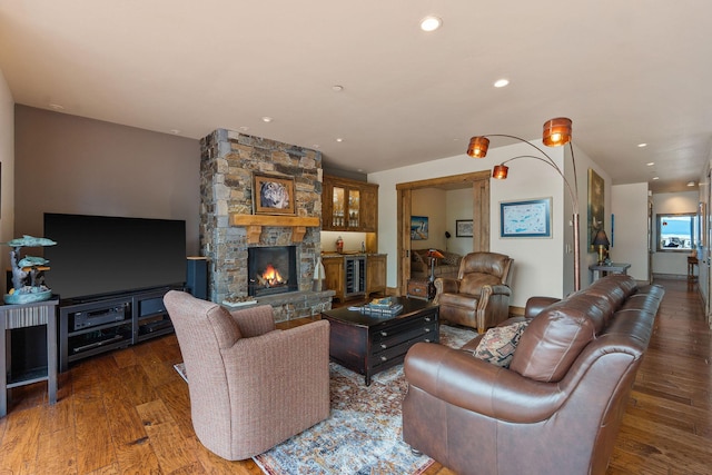 5675 US Highway 93 S Unit 10, Somers, MT 59932 - living room featuring wood finished floors, a stone fireplace, and recessed lighting