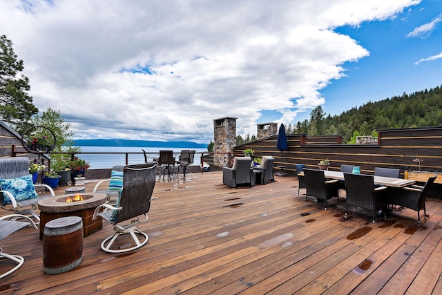 5675 US Highway 93 S Unit 10, Somers, MT 59932 - wooden terrace with an outdoor fire pit, outdoor dining area, and a water view