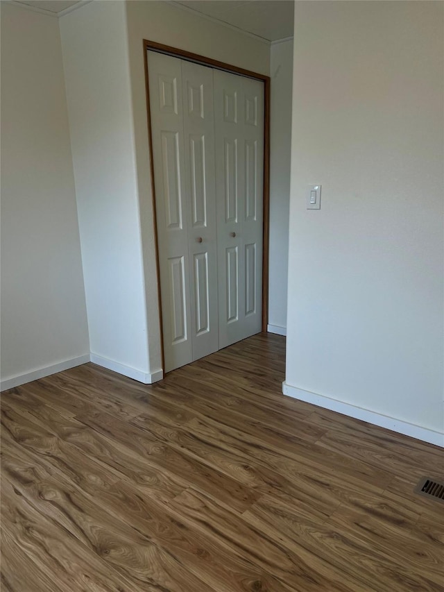 467 Grantsdale Rd Unit 16, Hamilton, MT 59840 - unfurnished bedroom with dark wood-style floors, baseboards, and a closet