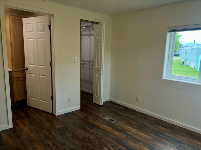467 Grantsdale Rd Unit 16, Hamilton, MT 59840 - unfurnished bedroom with dark wood finished floors, baseboards, a closet, and ornamental molding