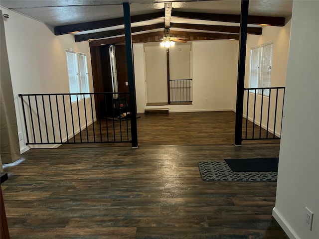 467 Grantsdale Rd Unit 16, Hamilton, MT 59840 - empty room with beam ceiling, wood finished floors, ceiling fan, and baseboards