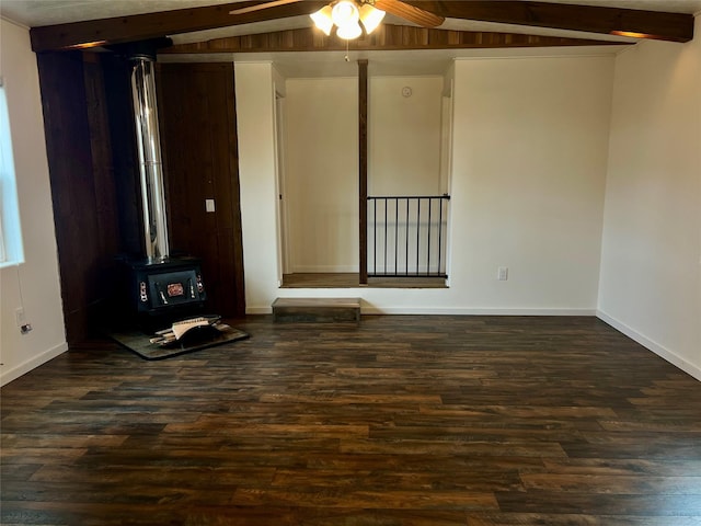 467 Grantsdale Rd Unit 16, Hamilton, MT 59840 - unfurnished living room featuring dark wood-style floors, beam ceiling, a ceiling fan, baseboards, and a wood stove