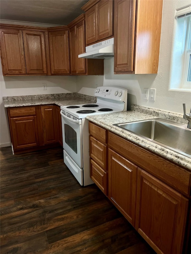 467 Grantsdale Rd Unit 16, Hamilton, MT 59840 - kitchen with white range with electric stovetop, under cabinet range hood, brown cabinets, and dark wood-type flooring