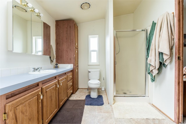 1709 20th Ave S, Great Falls, MT 59405 - bathroom with vanity, a stall shower, toilet, and tile patterned floors