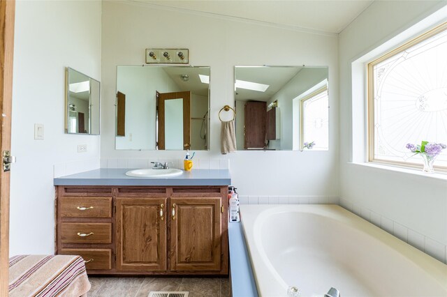 1709 20th Ave S, Great Falls, MT 59405 - bathroom featuring vanity, a garden tub, and tile patterned floors