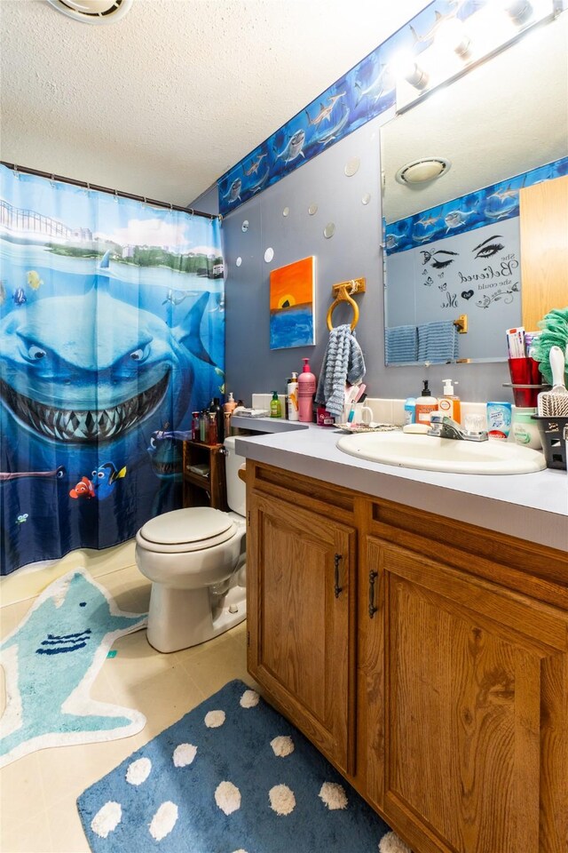 1709 20th Ave S, Great Falls, MT 59405 - bathroom with vanity, toilet, a textured ceiling, a shower with shower curtain, and tile patterned floors
