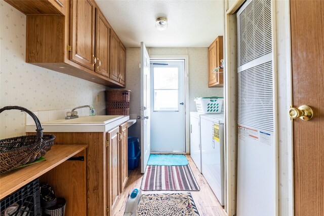 1709 20th Ave S, Great Falls, MT 59405 - laundry area featuring wallpapered walls, a heating unit, cabinet space, washing machine and dryer, and light wood-type flooring