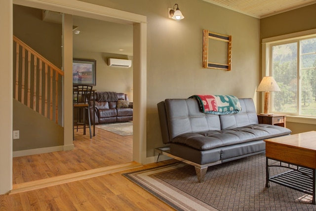2055 Diamond Match Rd, Superior, MT 59872 - living room featuring a wall mounted AC, wood finished floors, and stairs