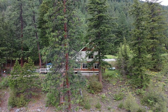 2055 Diamond Match Rd, Superior, MT 59872 - back of property featuring a forest view and a deck