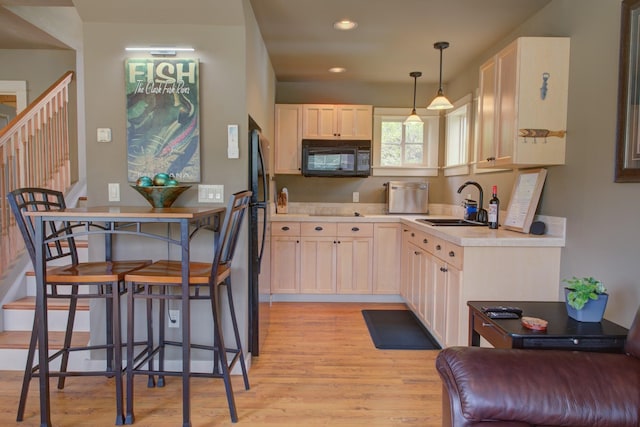 2055 Diamond Match Rd, Superior, MT 59872 - kitchen with black microwave, a sink, light wood finished floors, light countertops, and recessed lighting
