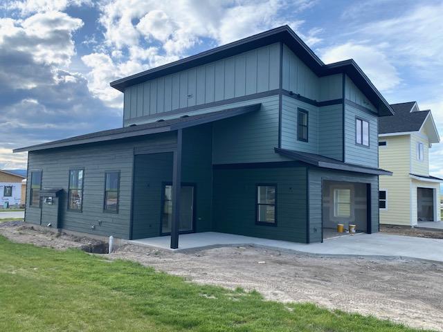 619 Holstein Way, Kalispell, MT 59901 - back of house with a patio area and a yard