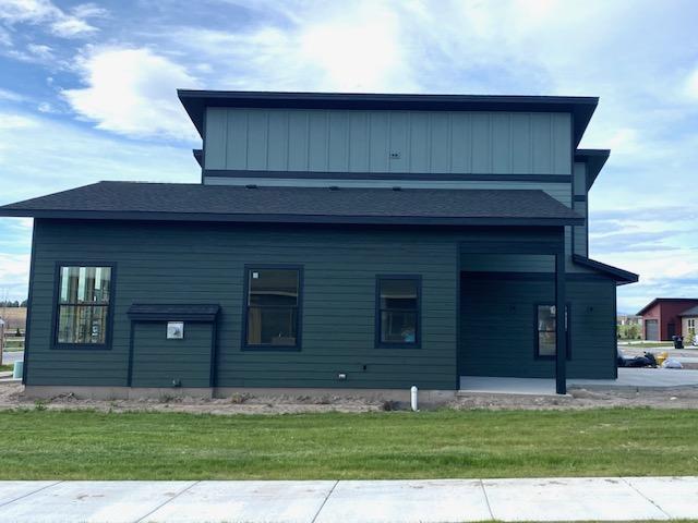 619 Holstein Way, Kalispell, MT 59901 - view of property exterior with a yard and board and batten siding