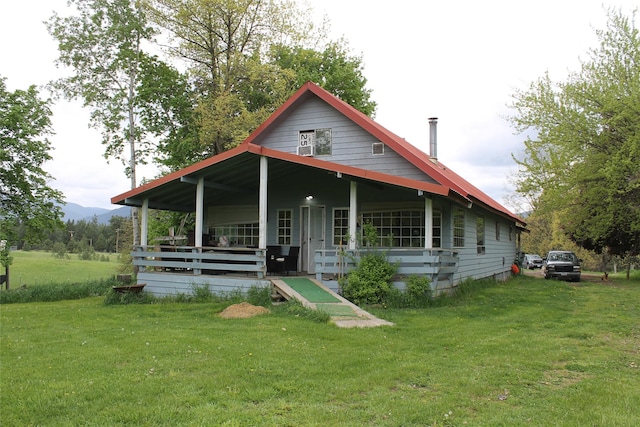303 Swamp Creek Loop Rd, Trout Creek, MT 59874 - view of front of home with a front yard, covered porch, and a mountain view