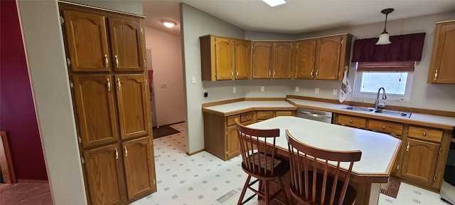 8 Teresa Ln, Great Falls, MT 59404 - kitchen with dishwasher, brown cabinetry, light flooring, decorative light fixtures, and light countertops