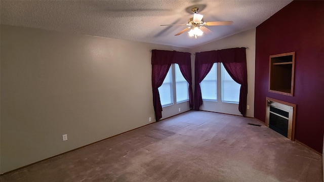8 Teresa Ln, Great Falls, MT 59404 - empty room with a textured ceiling, ceiling fan, carpet flooring, vaulted ceiling, and a fireplace