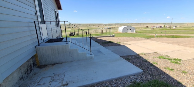 8 Teresa Ln, Great Falls, MT 59404 - view of patio / terrace featuring a shed and a rural view
