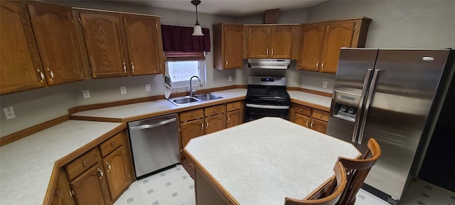 8 Teresa Ln, Great Falls, MT 59404 - kitchen featuring appliances with stainless steel finishes, under cabinet range hood, brown cabinetry, and decorative light fixtures