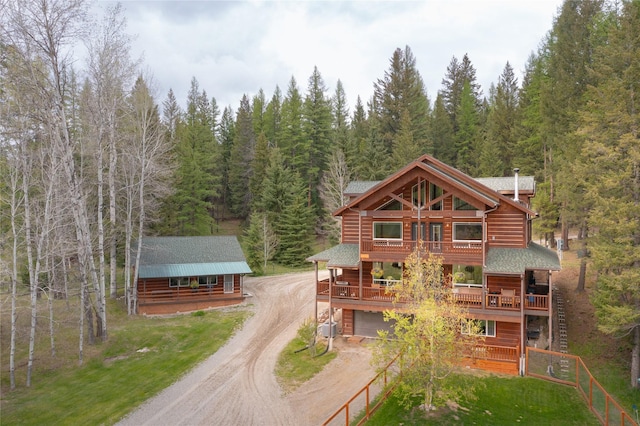 12520 Pinkham Creek Rd, Rexford, MT 59930 - view of front of house featuring driveway, a forest view, a wooden deck, and stairway