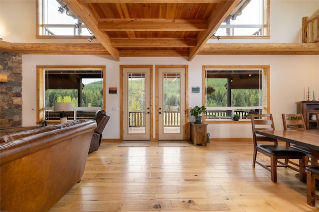 12520 Pinkham Creek Rd, Rexford, MT 59930 - living room featuring wooden ceiling with exposed beams, baseboards, and light wood-style floors