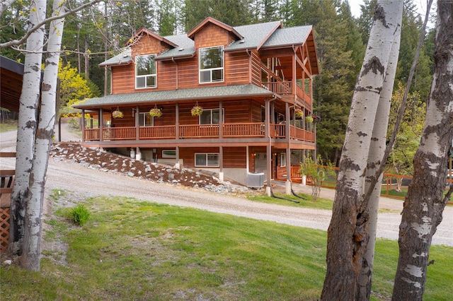 12520 Pinkham Creek Rd, Rexford, MT 59930 - chalet / cabin with cooling unit, a front lawn, driveway, and roof with shingles