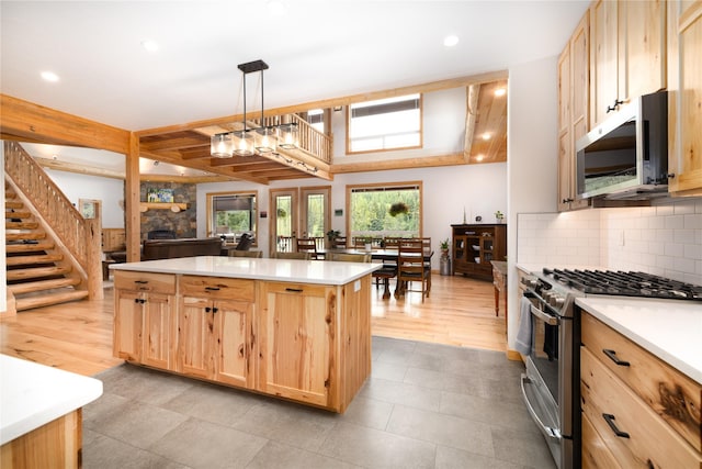 12520 Pinkham Creek Rd, Rexford, MT 59930 - kitchen with appliances with stainless steel finishes, light brown cabinetry, a stone fireplace, light countertops, and recessed lighting