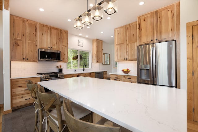 12520 Pinkham Creek Rd, Rexford, MT 59930 - kitchen featuring appliances with stainless steel finishes, recessed lighting, decorative backsplash, light countertops, and a center island