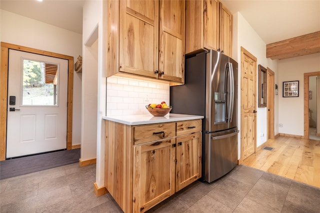 12520 Pinkham Creek Rd, Rexford, MT 59930 - kitchen featuring stainless steel fridge, decorative backsplash, light countertops, baseboards, and light tile patterned flooring